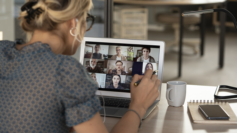 Woman on a laptop in a video conference call with co-workers